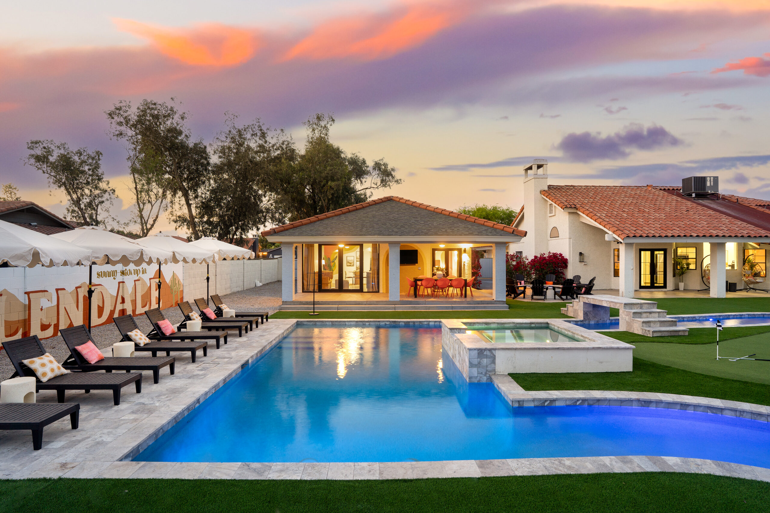 Rectangular pool and raised spa at dusk in Glendale, AZ