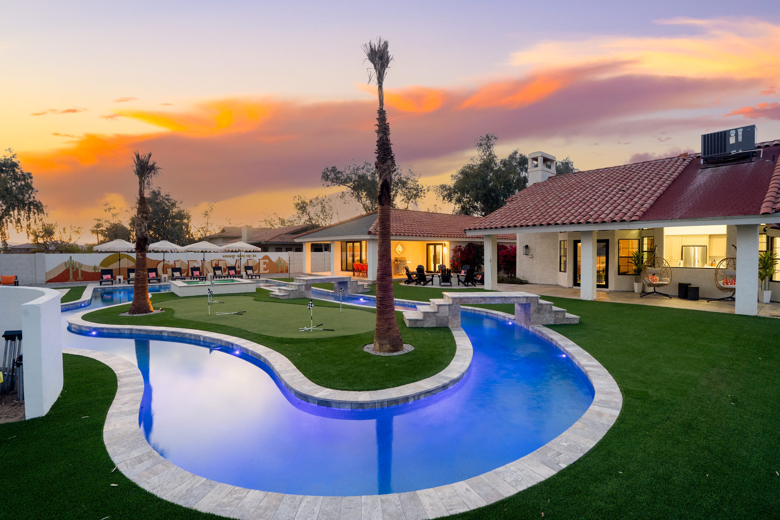 Lazy river curving through artificial turf at dusk in Glendale, AZ