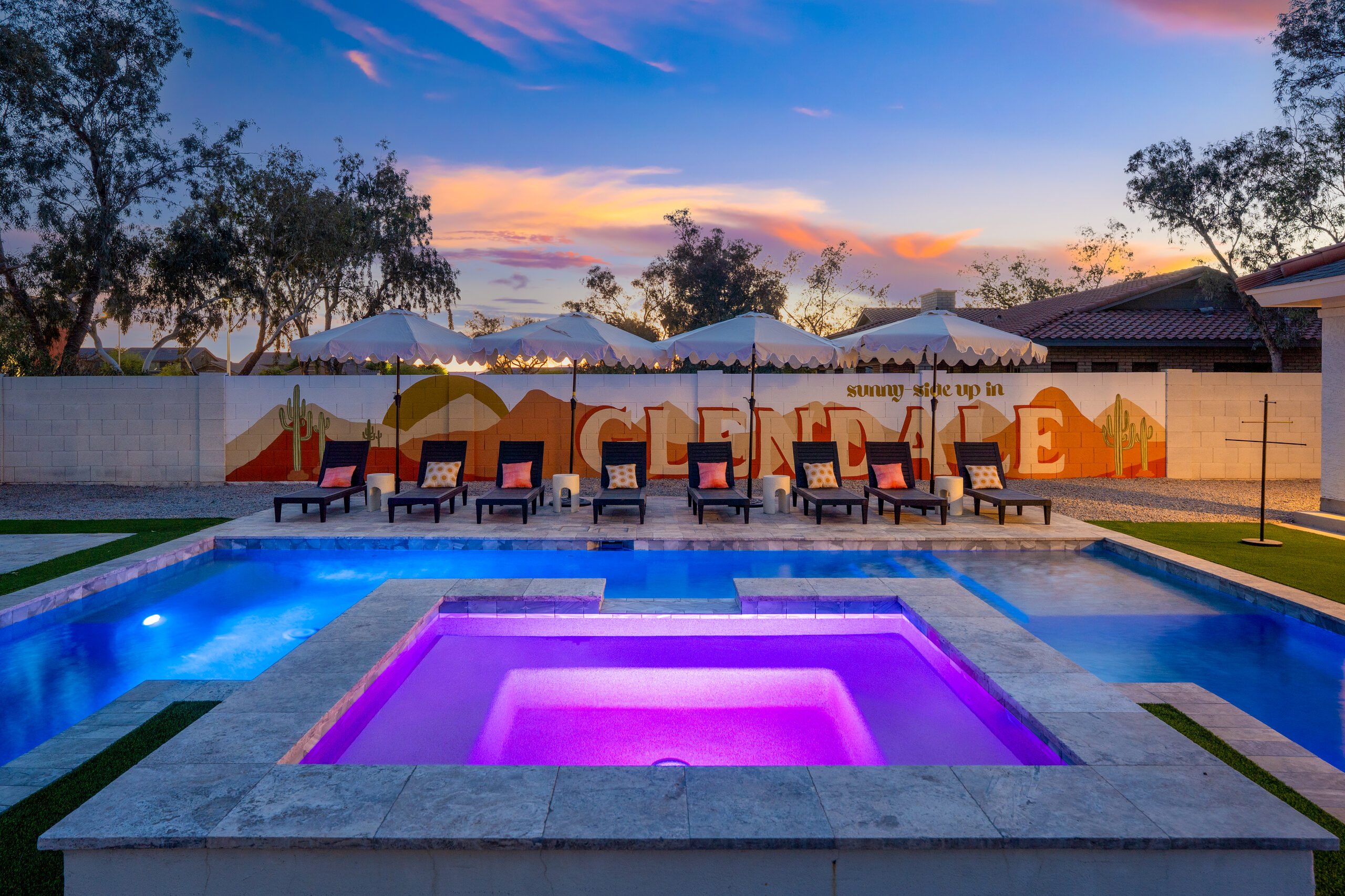 Raised spa with color changing lighting beside a pool in Glendale, AZ
