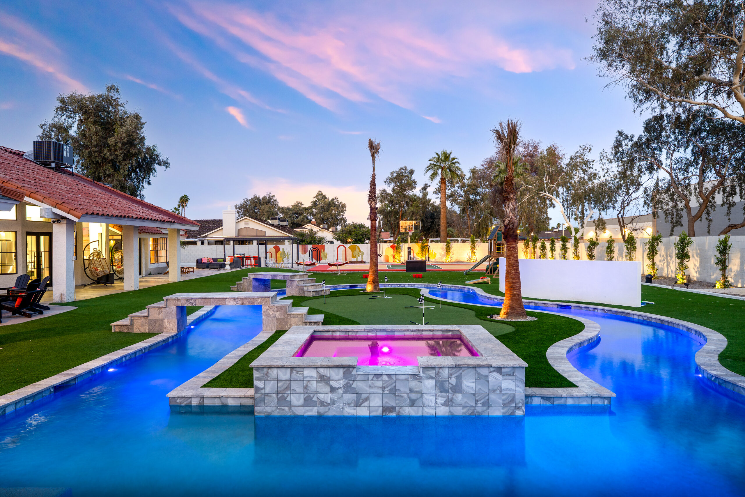 Lazy river, spa and outdoor movie screen at dusk in Glendale, AZ
