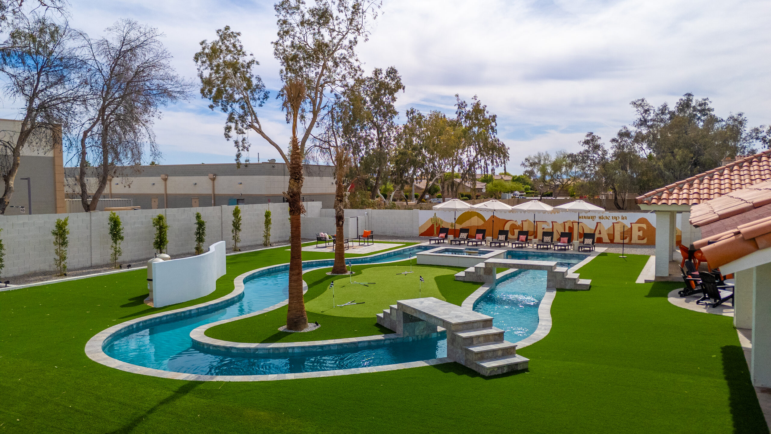 Lazy river and putting green in a Glendale, AZ backyard
