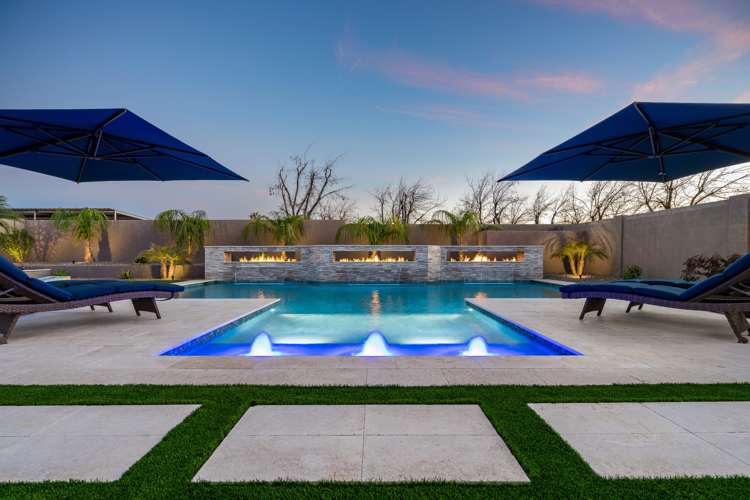 Custom pool with cantilever umbrellas and fire wall in Queen Creek, AZ