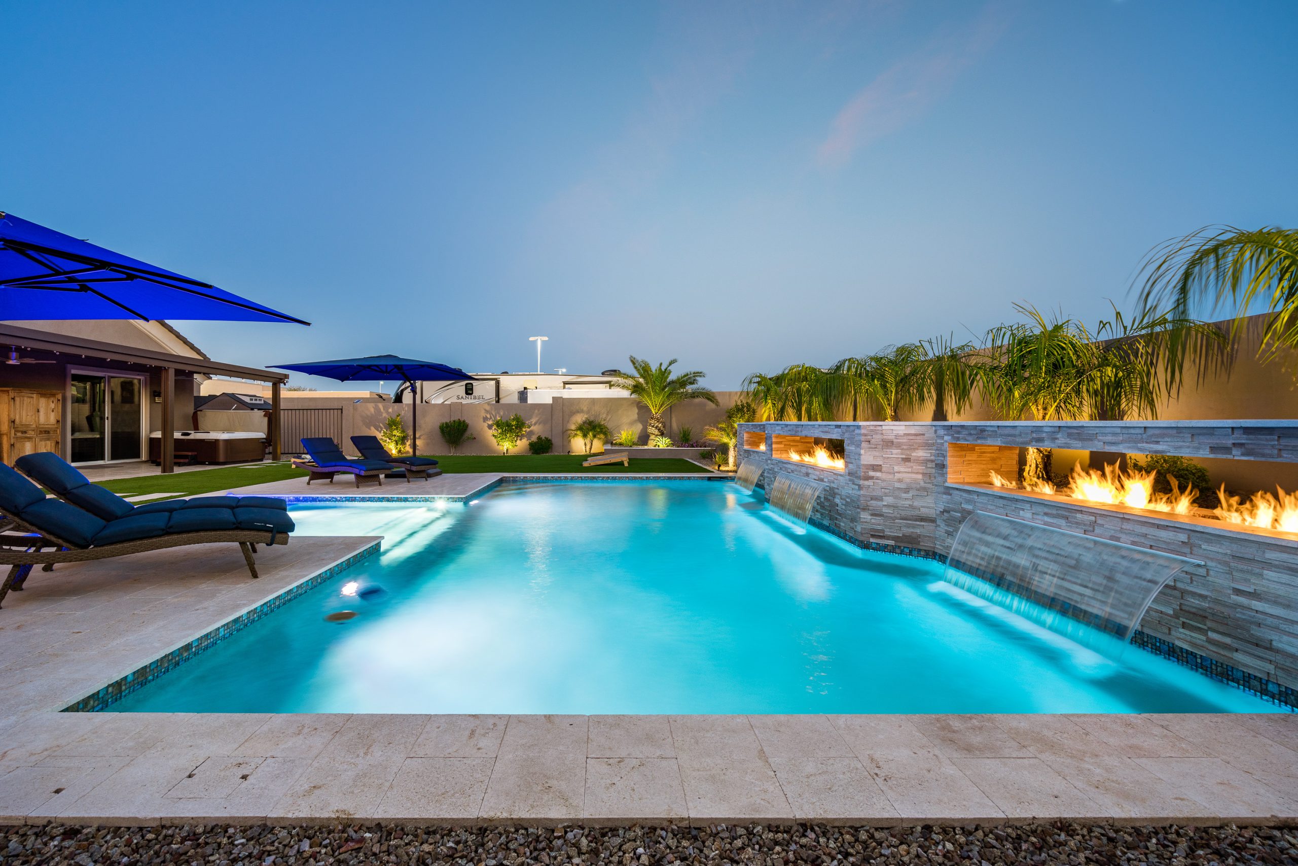 Geometric pool lit at dusk with fire feature in Queen Creek, AZ