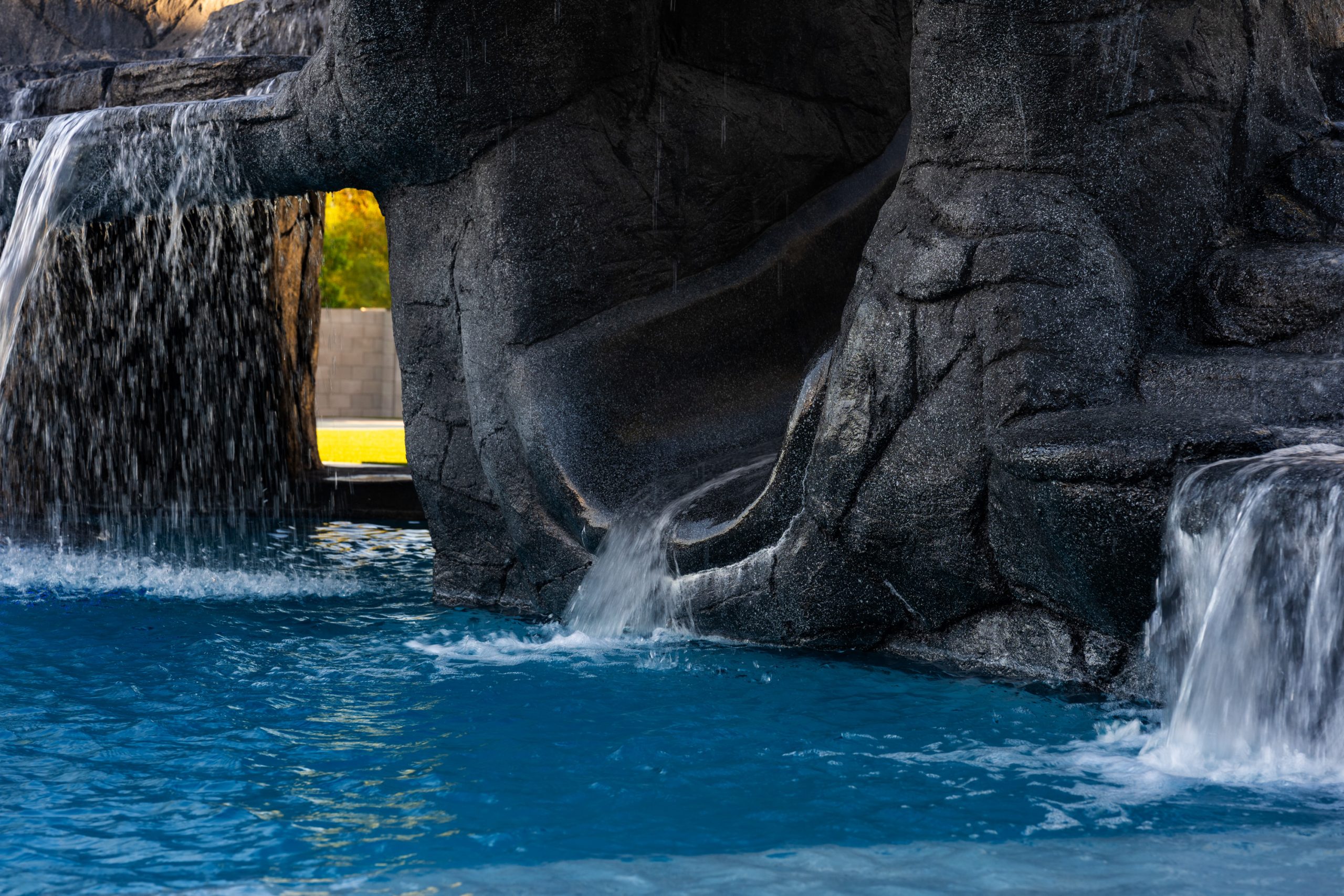 Custom rock waterfall cascading into a freeform pool in Gilbert, AZ