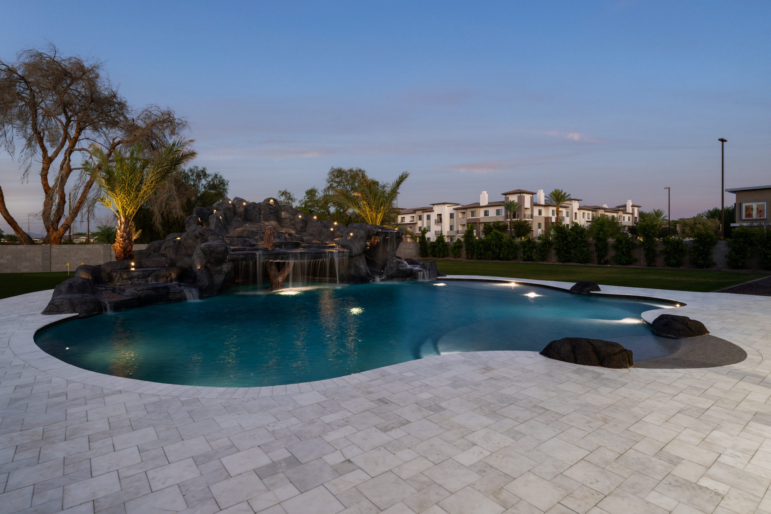 Illuminated freeform pool and rock grotto in Gilbert, AZ