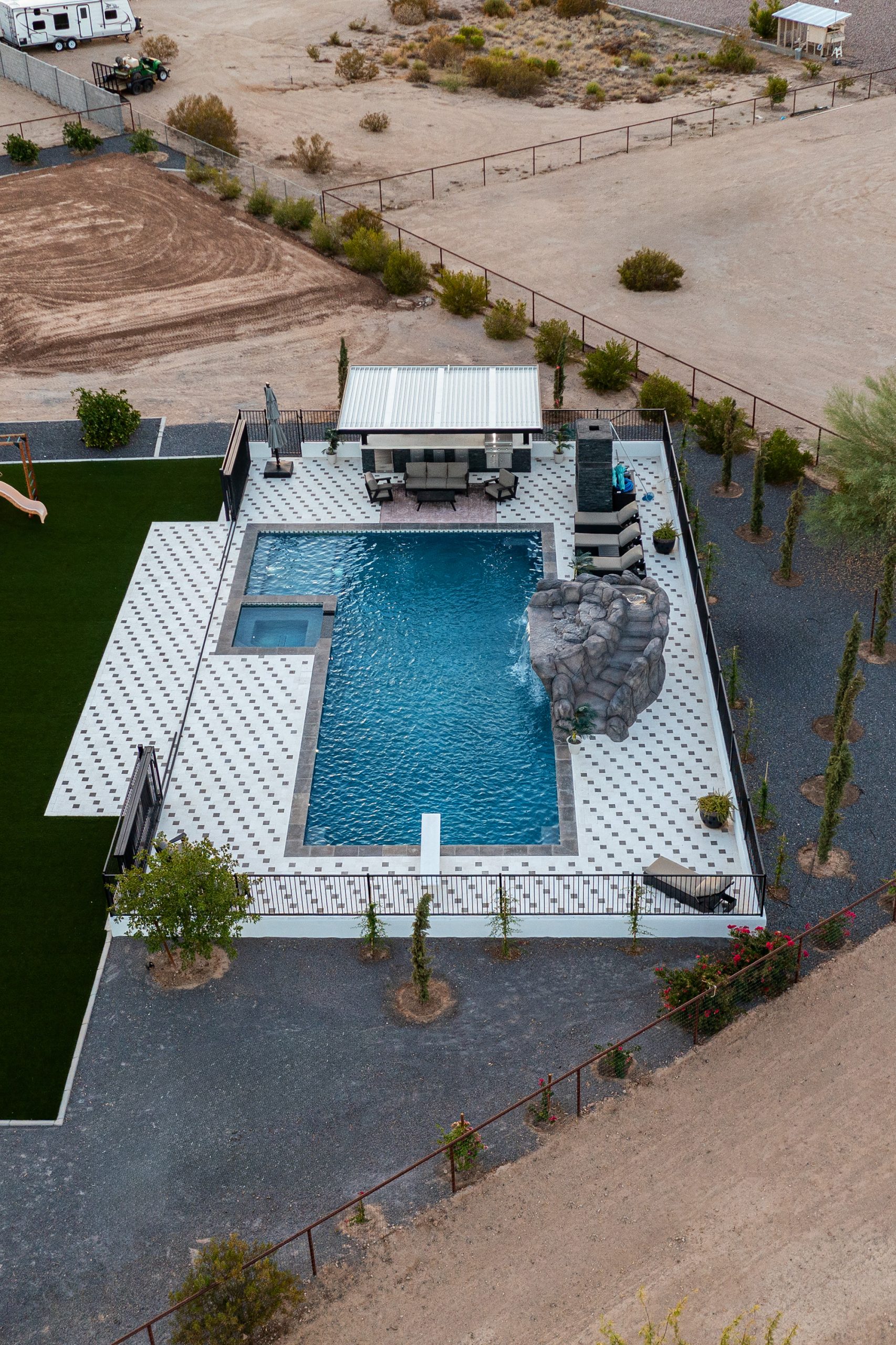 Aerial of a geometric pool with rock waterfall in San Tan Valley, AZ