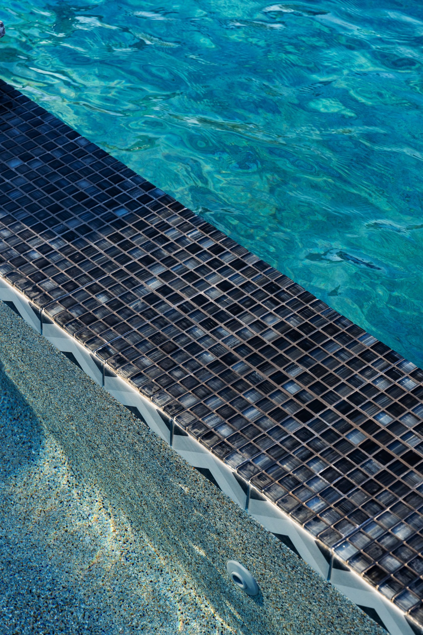 Dark mosaic waterline tile detail on a custom pool in San Tan Valley, AZ