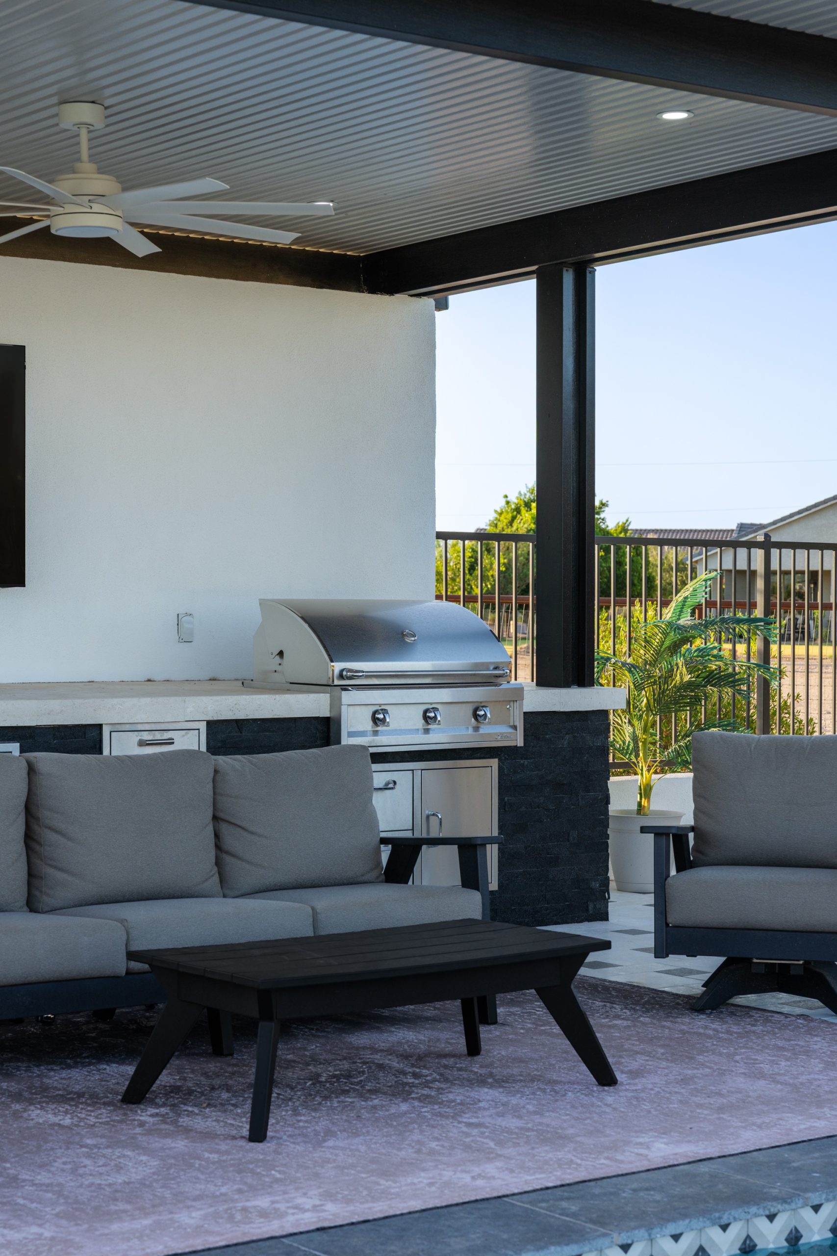 Outdoor kitchen with built-in grill under a pergola in San Tan Valley, AZ