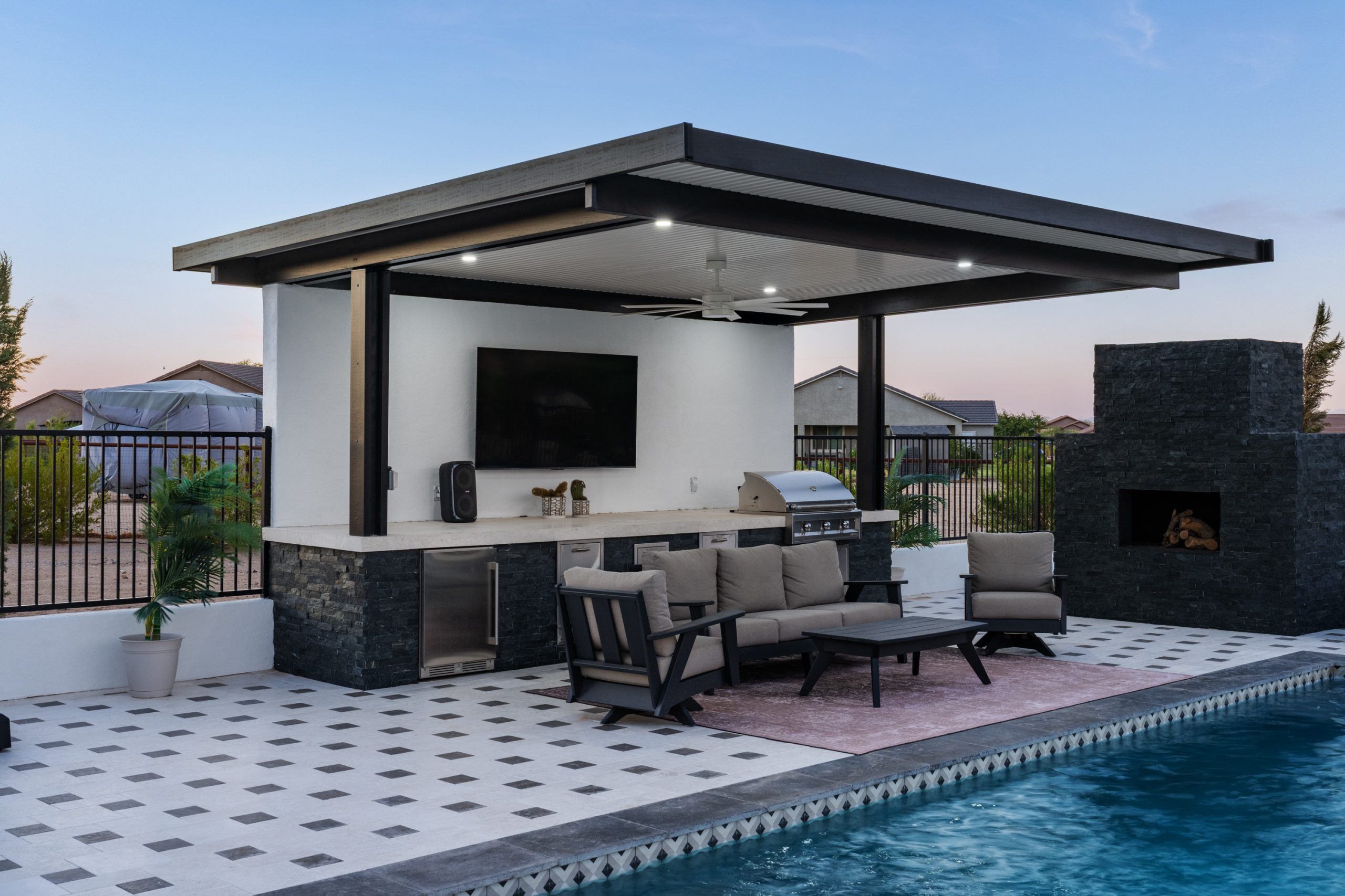 Outdoor living pergola with stacked stone fireplace in San Tan Valley, AZ