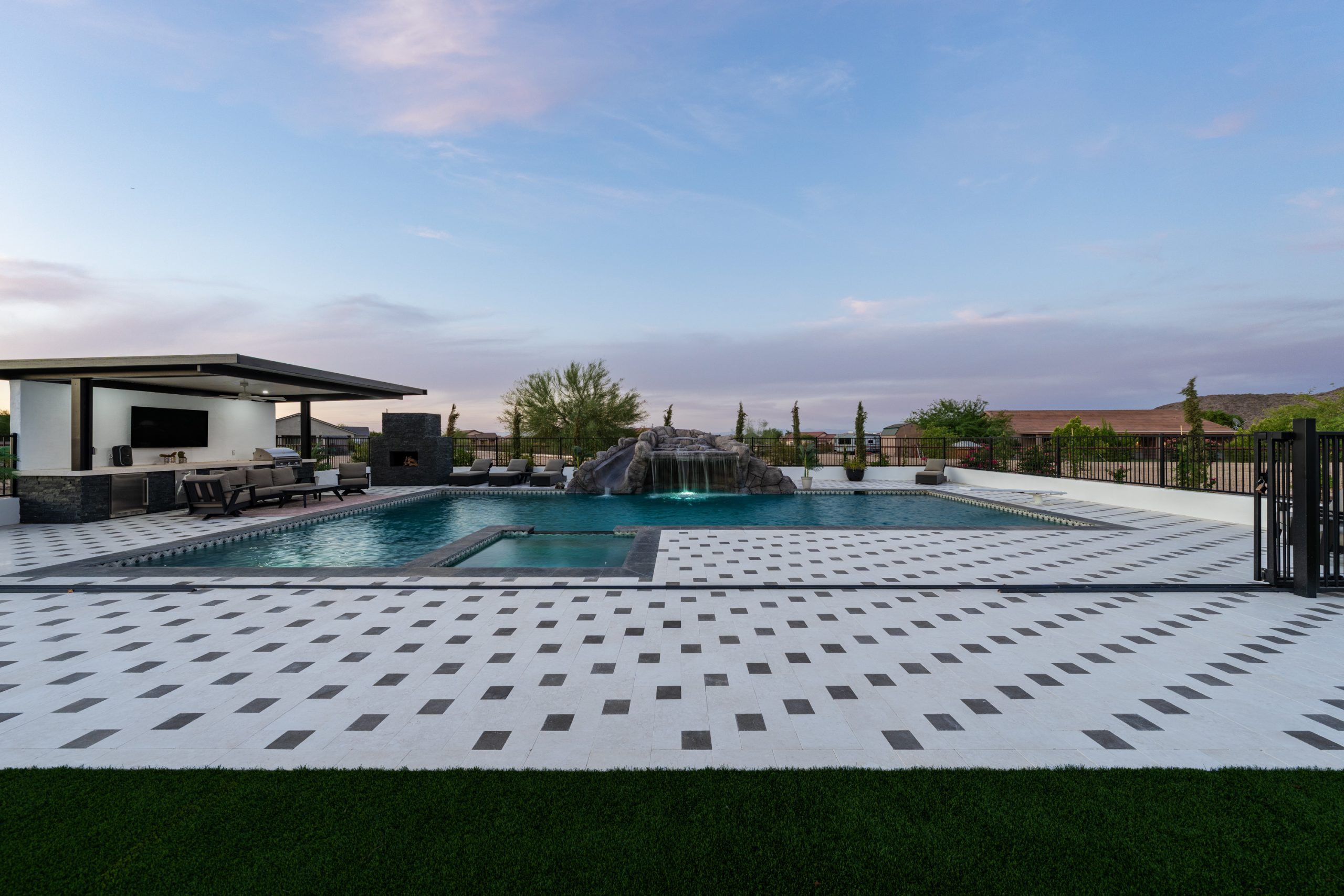 Wide view of a custom pool and checkerboard paver decking in San Tan Valley, AZ