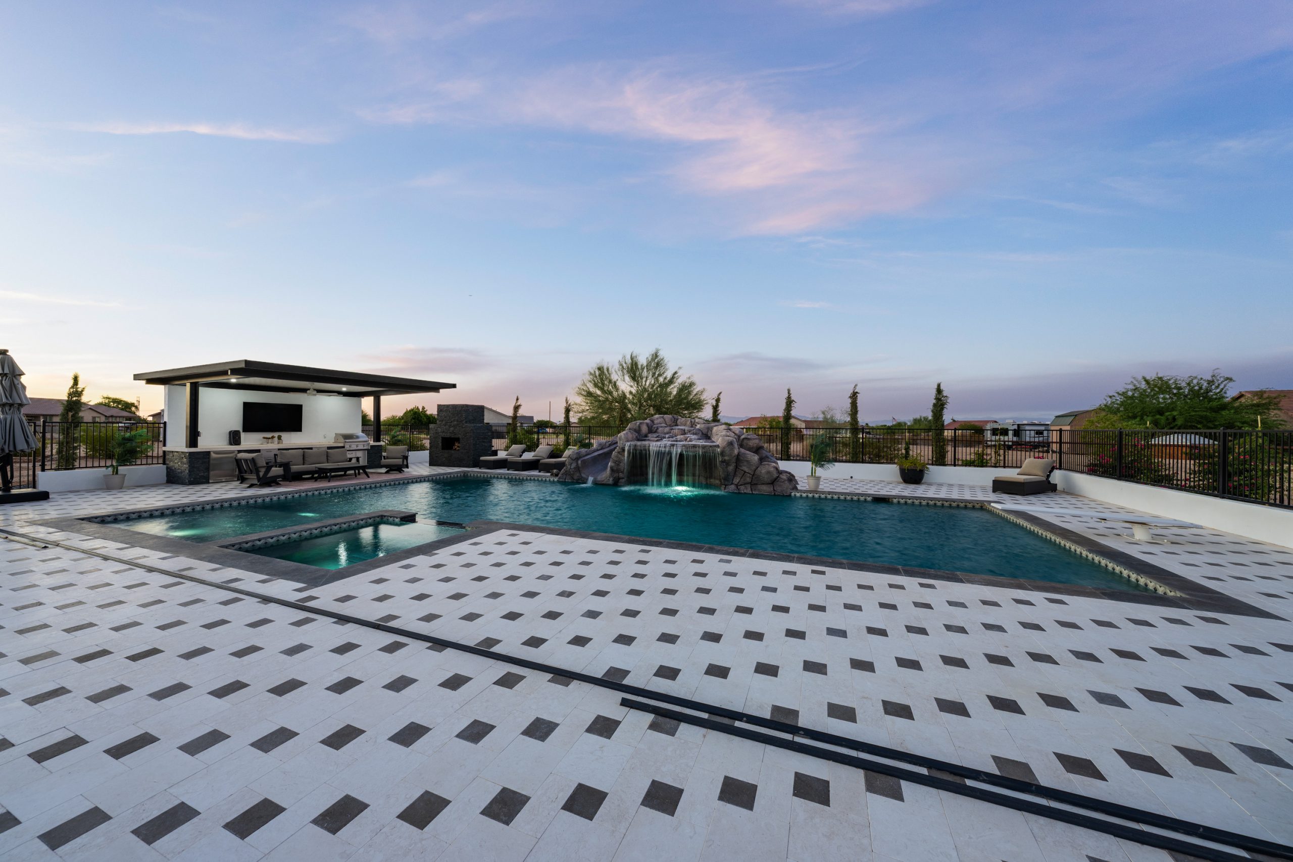 Geometric pool with raised spa at dusk in San Tan Valley, AZ