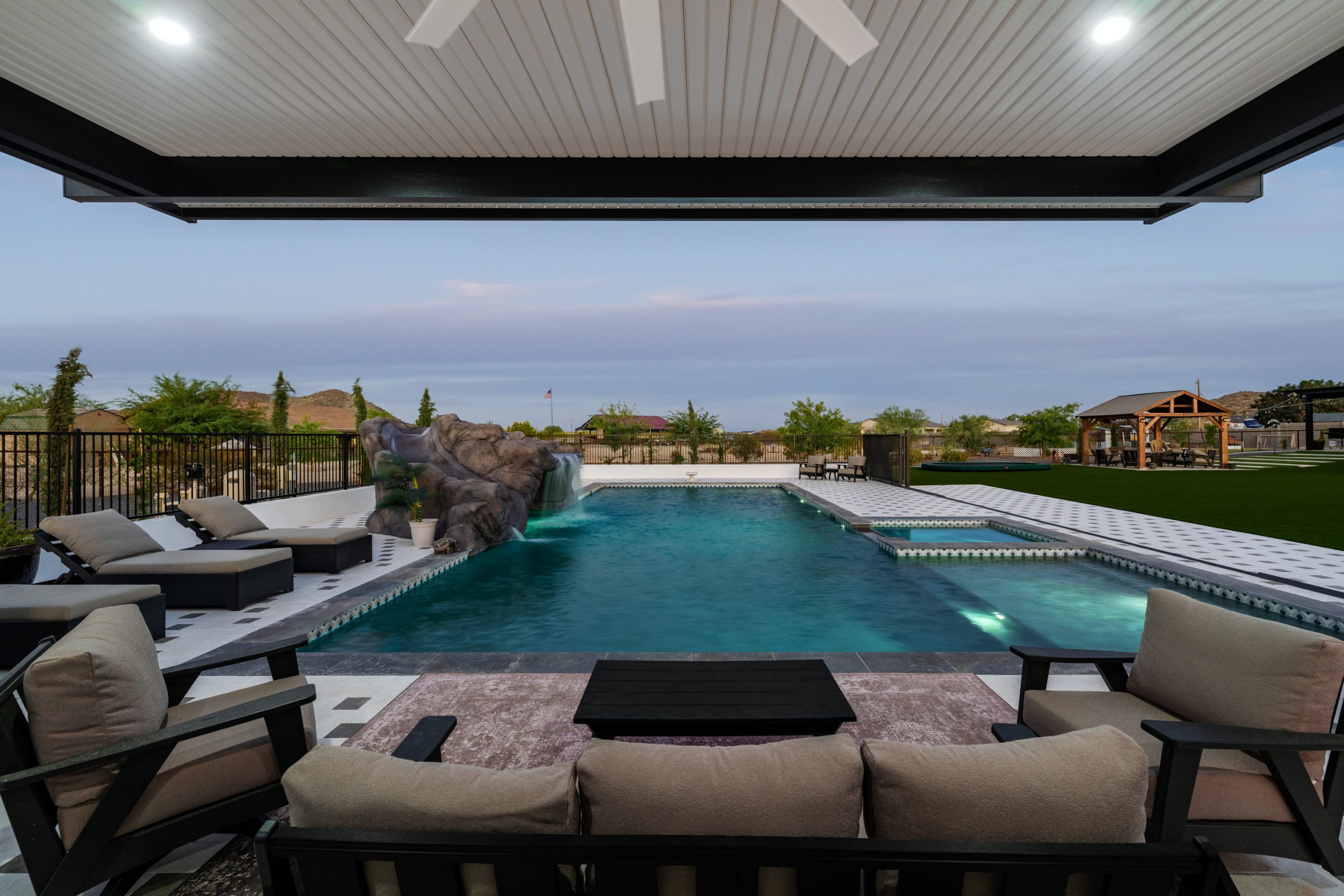 Covered pergola and pool at dusk in San Tan Valley, AZ