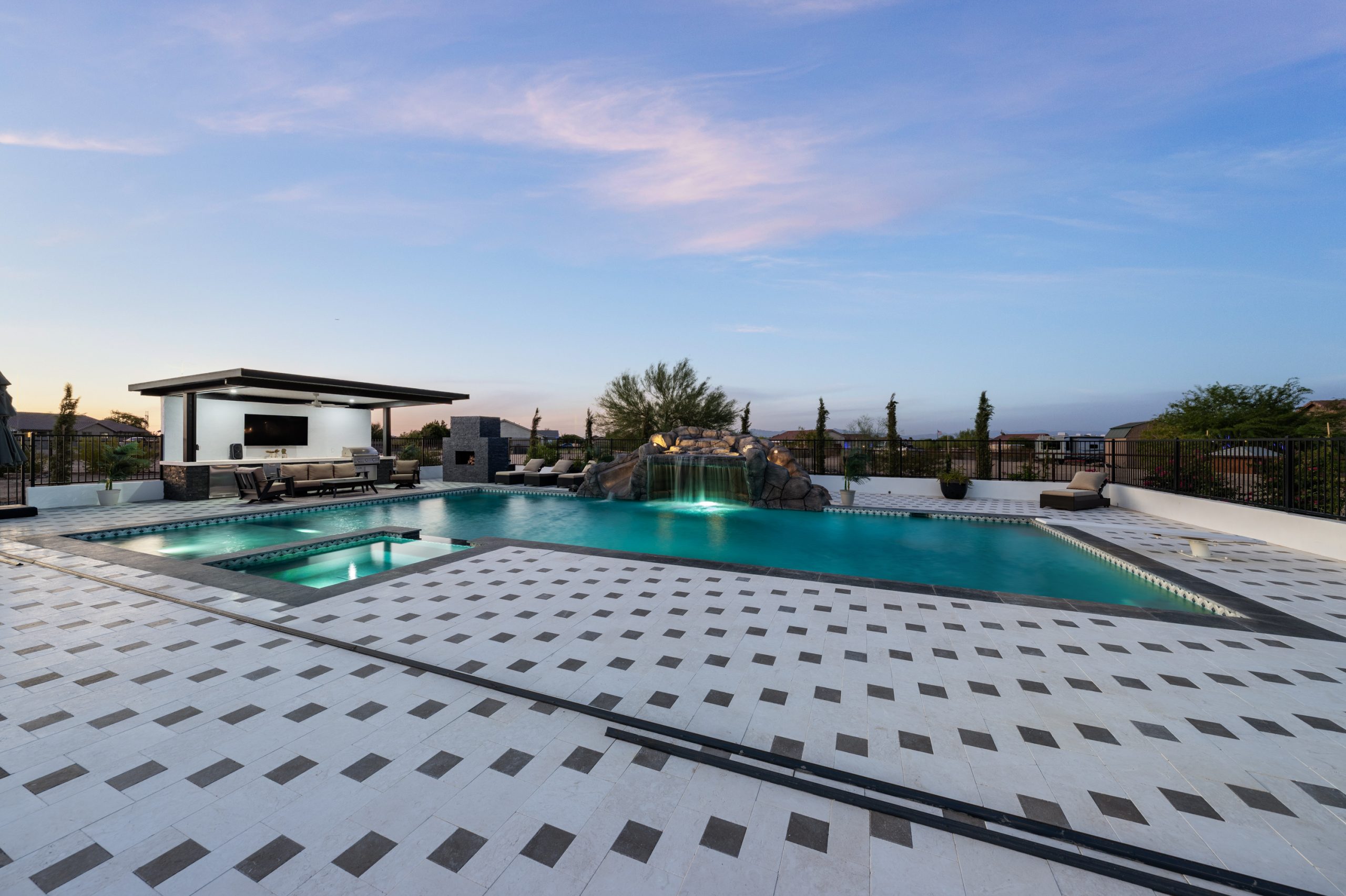 Backyard pool and outdoor living space at dusk in San Tan Valley, AZ