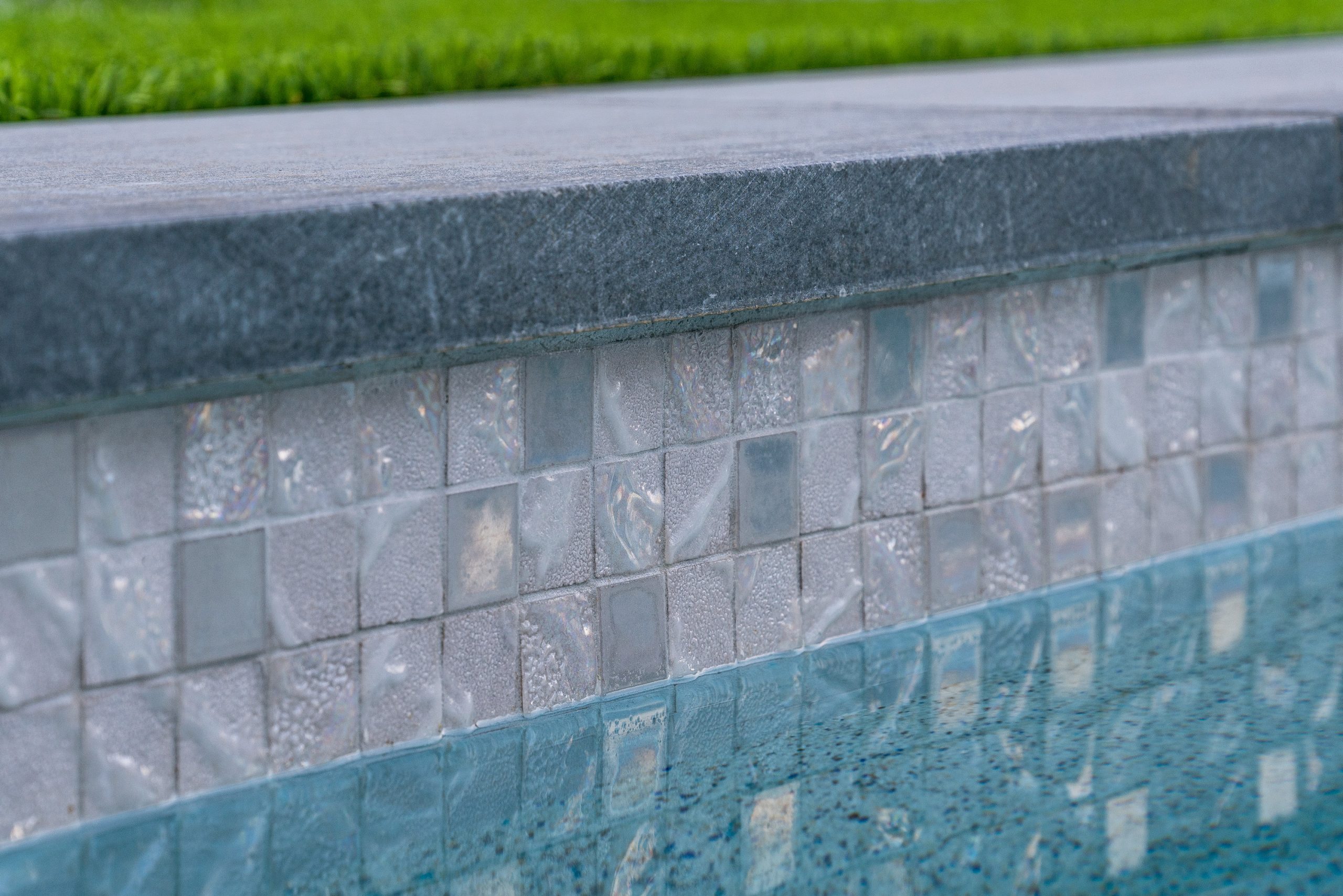 Glass mosaic tile and stone coping detail on a Scottsdale, AZ pool