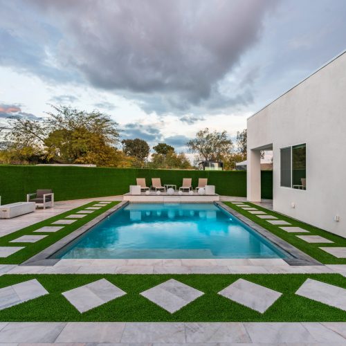 Modern geometric pool and covered patio at dusk in Scottsdale, AZ