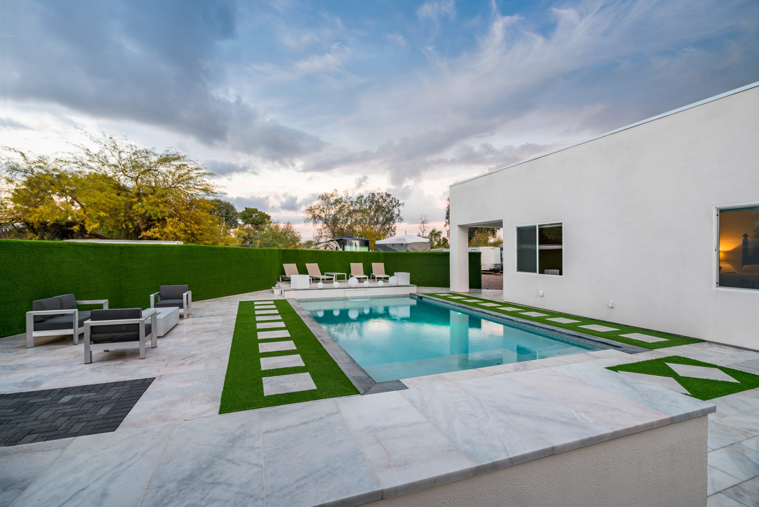 Custom rectangular pool and turf decking at dusk in Scottsdale, AZ