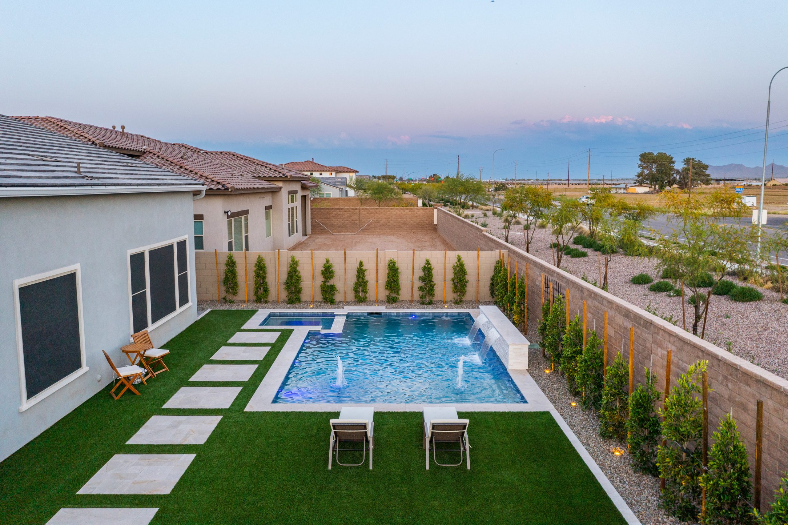 Aerial of a modern pool and covered patio at dusk in Gilbert, AZ