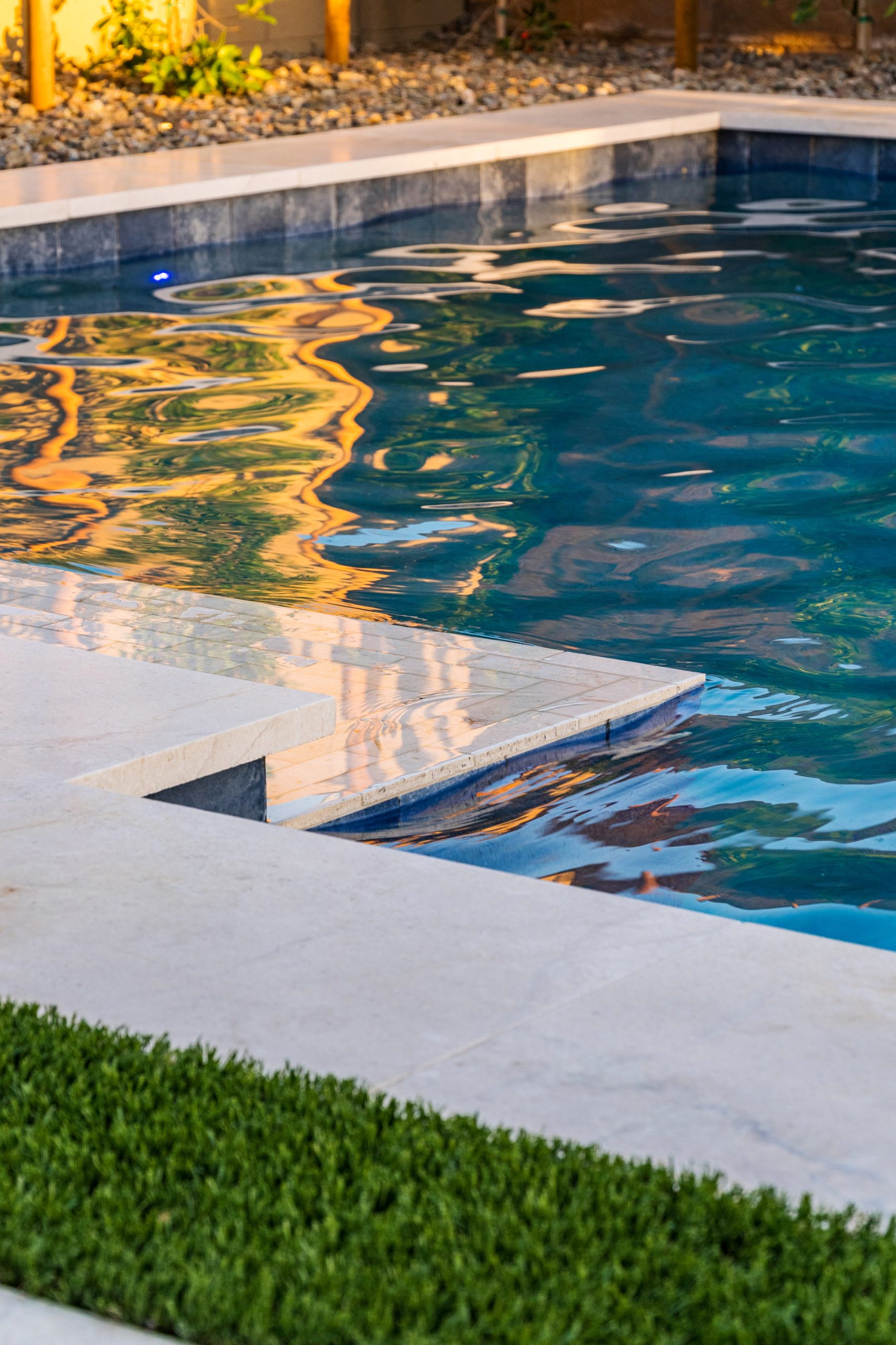 Corner view of a rectangular pool with turf decking in Gilbert, AZ