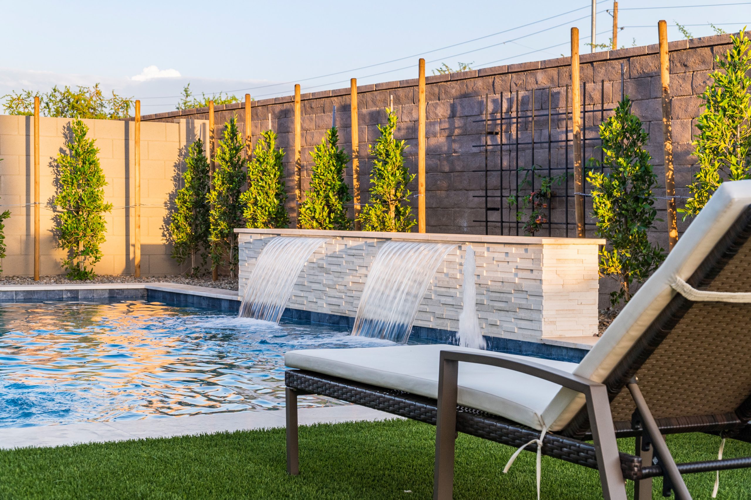 Sheer descents spilling into a geometric pool in Gilbert, AZ
