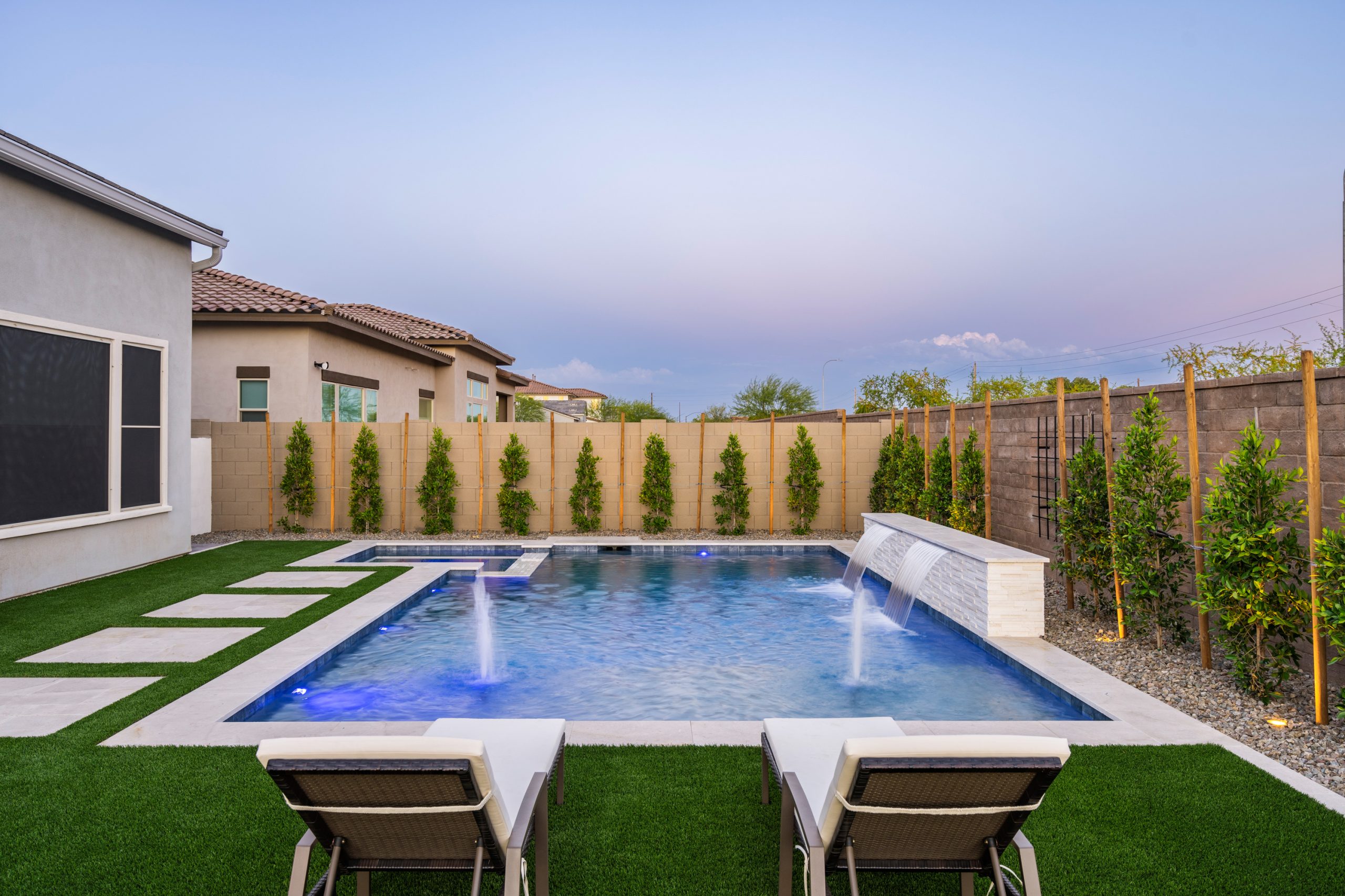 Poolside lounge seating and water feature wall in Gilbert, AZ