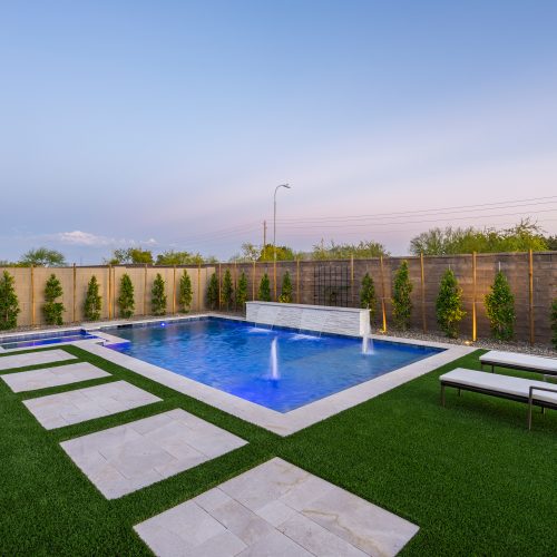 Rectangular pool with deck jets and turf decking in Gilbert, AZ