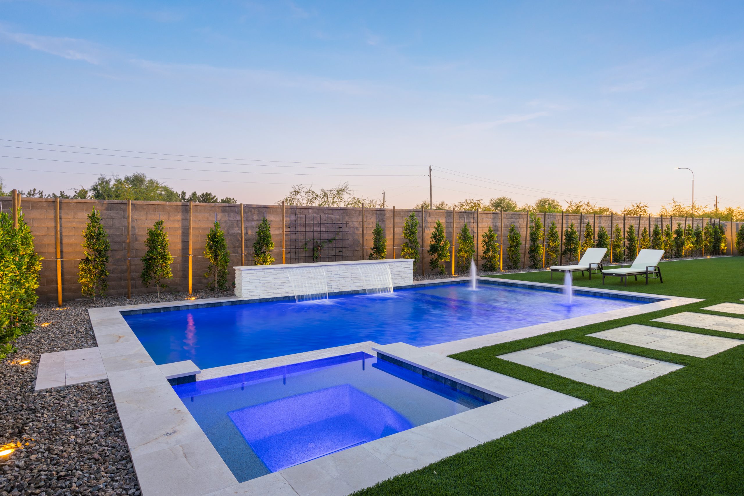 Raised spa spilling into a custom pool in Gilbert, AZ