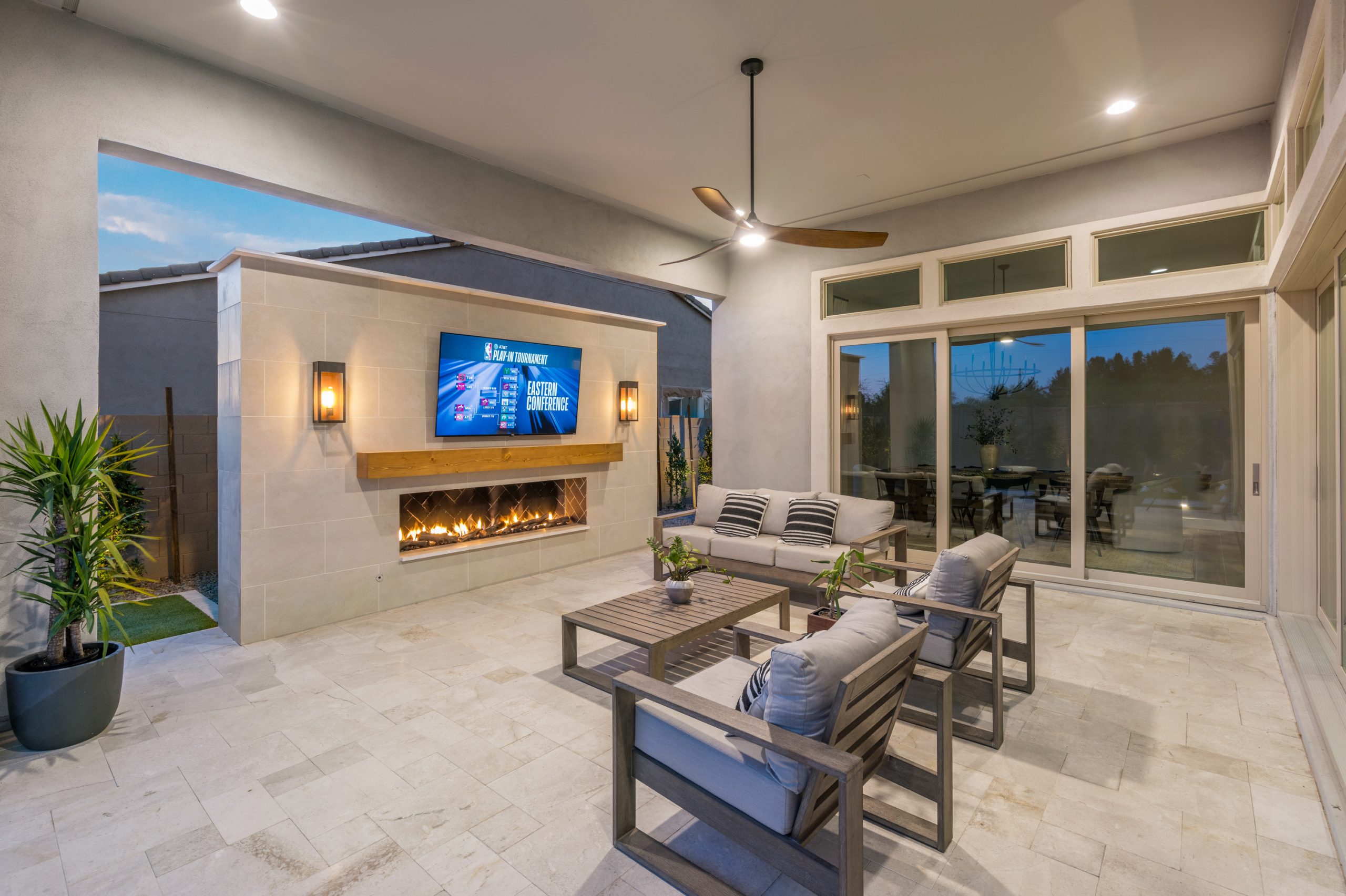 Covered patio with a linear gas fireplace in Gilbert, AZ
