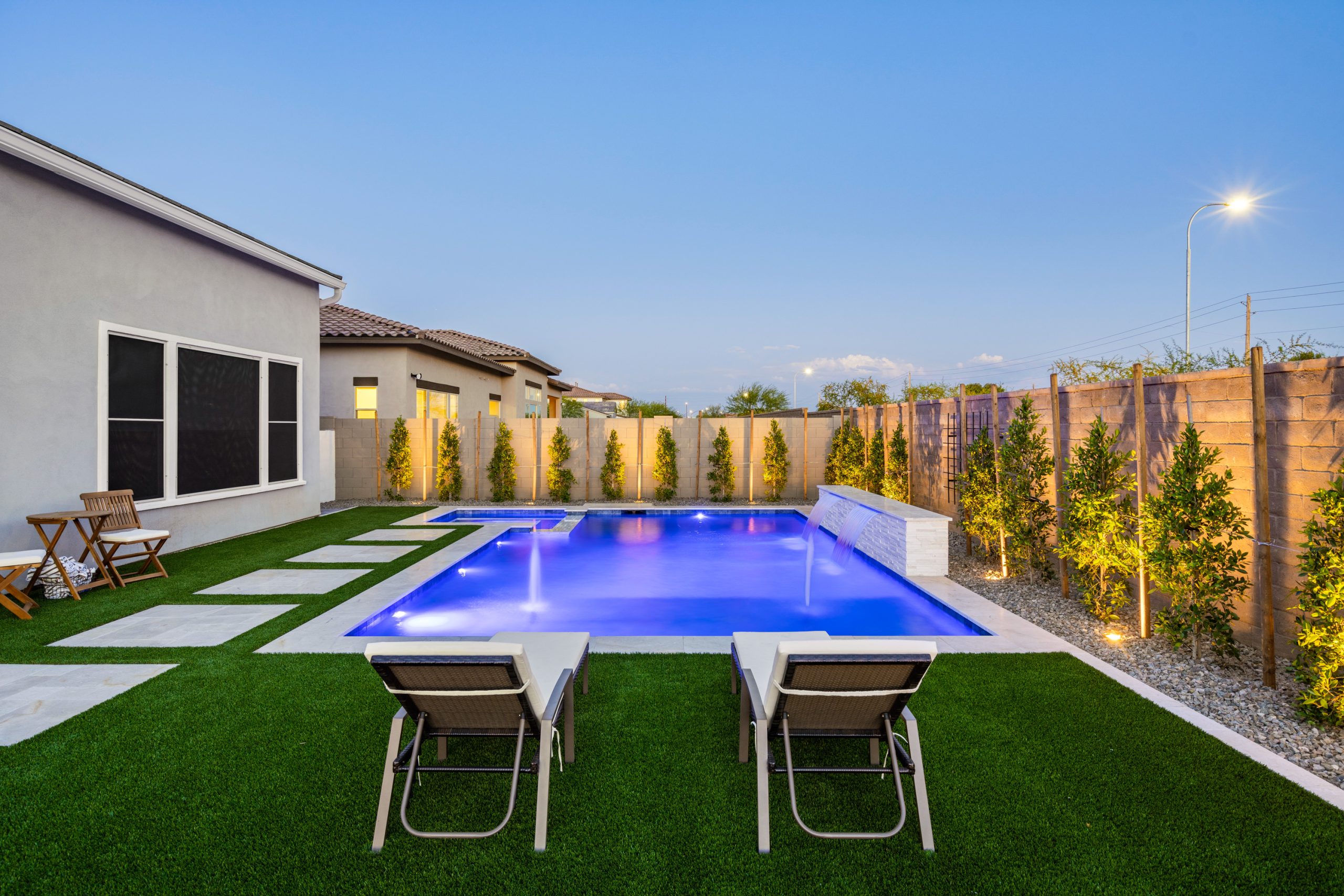 Custom pool and paver stepping stones at dusk in Gilbert, AZ